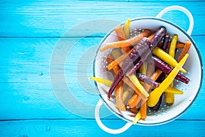 Vibrant colorful rainbow carrots in colander