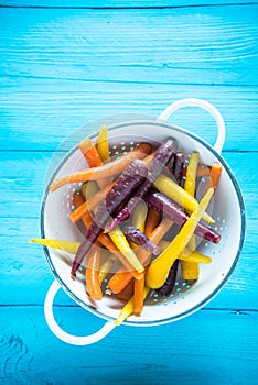 Vibrant colorful rainbow carrots in colander