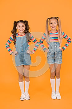 Vibrant colors. Modern fashion. Kids fashion. Girls long hair. Cute children same outfits. Little girls wearing rainbow