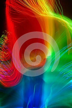 Vibrant coloured light trails from fibre optic strands.