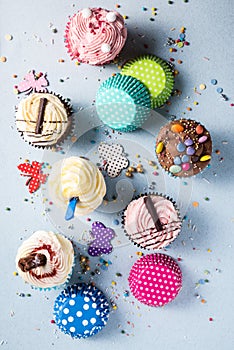 Vibrant cupcakes on blue background, party food concept