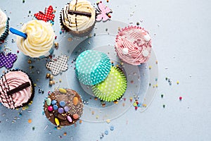 Vibrant cupcakes on blue background, party food concept