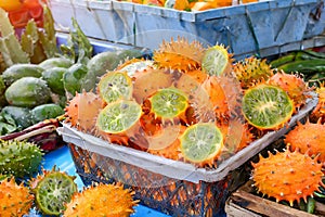 A vibrant display of freshly picked kiwano, glistening under the sun, ready for sale. African Spiny Melon, African Cucumber, Fruit