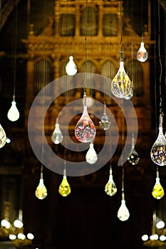 Vibrant display of illuminated light bulbs against a backdrop of an ancient brick building