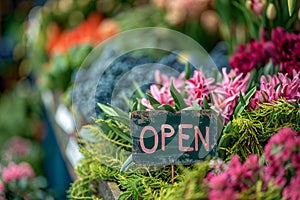 Vibrant Flower Shop Display Welcoming Customers with Open Sign