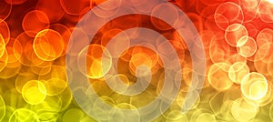 Vibrant gradient bokeh lights in yellow, orange, and red tones for abstract background