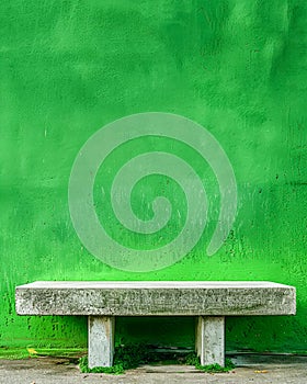 Vibrant Green Urban Wall with Empty Concrete Bench on Sidewalk Minimalist Cityscape Background for Poster or Wallpaper Design
