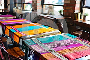 vibrant handwoven tablecloths on each cafe table