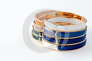 Assorted Colorful Bangles in Gold, Silver, and Enamel on White Background