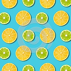 Vibrant lemon and green lime slices texture on turquoise background