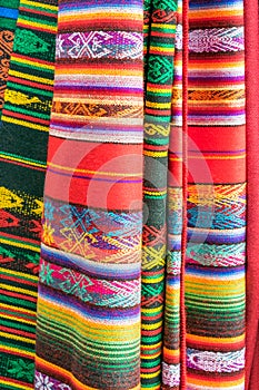 Hanging Colorful Mexican blankets with diverse patterns photo