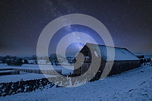 Vibrant Milky Way composite image over landscape of Snow covered