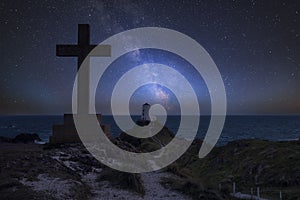 Vibrant Milky Way composite image over landscape of Ynys Llanddwyn Island in Angelsey