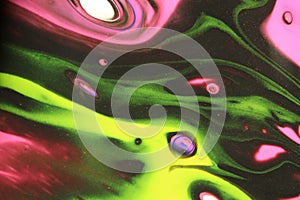 Vibrant neon yellow, green, and pink dance in black space in this abstract background.