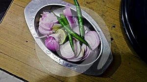 Vibrant onion salad on sleek steel servers, mussoorie