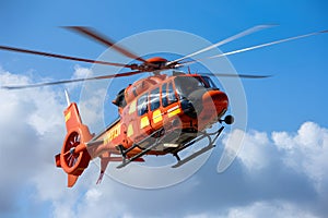 Vibrant orange fire helicopter soars through the sky on mission