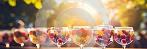 Vibrant outdoor brunch with colorful cocktails, fresh fruit platters, and dreamy bokeh backdrop