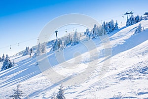 Vibrant panorama of the slopes at ski resort Kopaonik, Serbia, snow trees, blue sky