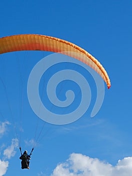 Vibrant paraglide parachute against blue vivid sky. Concept of freedom, holidays, extreme sport