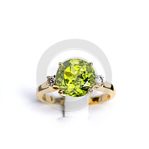 A vibrant peridot gemstone graces the center of a glossy, tarnish-resistant, yellow gold ring. The ring is accented with multiple