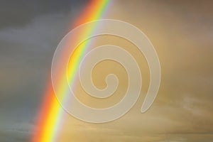 Vibrant rainbow against a dramatic cloudy sky at sunset