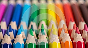 Vibrant rainbow array of sharpened colored pencils ready for artistic creation