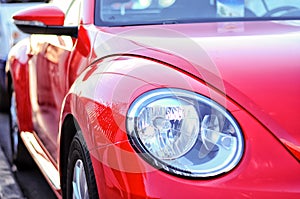 Vibrant red colour car side view and detailed car light. Modern