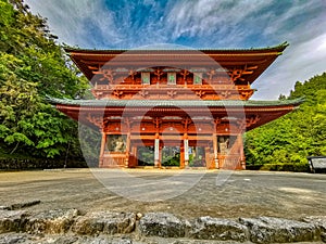 The vibrant red Daimon gate functioning as the entrance to the famous pilgrimage town Koyasan in Wakayama, Kansai, Japan