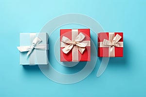 Vibrant red gift box decorated with white satin ribbon and bow, against a pastel blue backdrop