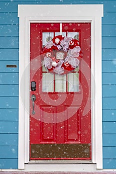 Vibrant red glass paned front door with wreath