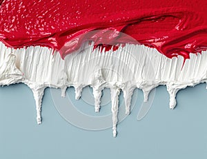 Vibrant red paint dripping over white surface