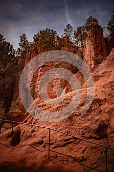 Vibrant red rock formations in the picturesque village of Roussillon in Provence, France