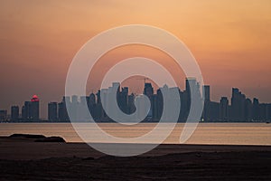 Vibrant Skyline of Doha at dramatick sunset as seen from the opposite side of the capital city bay