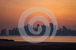 Vibrant Skyline of Doha at dramatick sunset as seen from the opposite side of the capital city bay