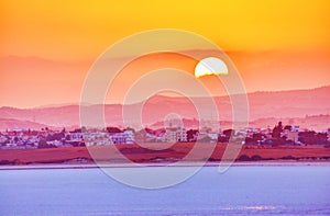 Vibrant and soften view of nice sunset over dry salt lake in Cyprus Larnaca in summer photo