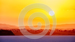 Vibrant and soften view of nice sunset over dry salt lake in Cyprus Larnaca in summer