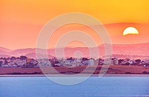 Vibrant and soften view of nice sunset over dry salt lake in Cyprus Larnaca in summer