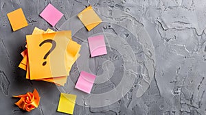 A vibrant stack of orange sticky notes with a question mark symbolizes confusion amidst a backdrop of crumpled pastels