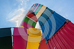 Vibrant storage structure comprised of multiple shipping containers stacked atop one another