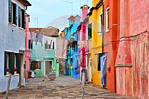 Vibrant street with laundry in colorful Burano near Venice, Italy
