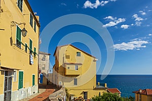 Vibrant streets of mediterranian town with deep blue sky and sea photo
