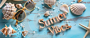 A Vibrant Summer Scene With Sunglasses And Seashells Spelling Out Summer Vibes