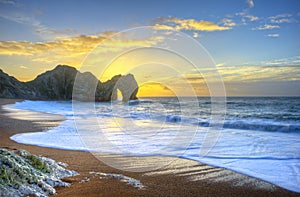 Vibrant sunrise over ocean with rock stack in foreground