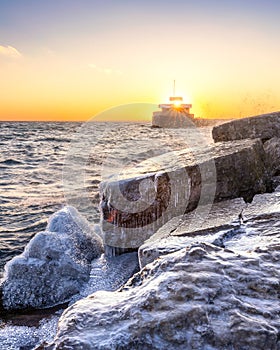 Vibrant sunset over an icy Winter Ontario Place in Toronto with decommissioned old Great Lakes freighters