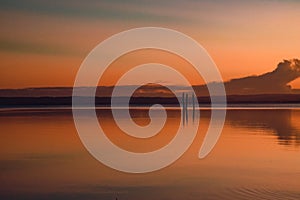 Vibrant sunset sky over Tuggerah Lake from Canton Beach in Toukley, NSW Australia photo