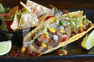 Vibrant Taco Platter with Fresh Vegetables and Zesty Lime Accents photo