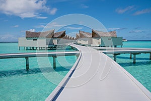 Vibrant tropical landscape of the over water villas at luxury resort in Maldives