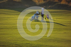 Vibrant view of golf course in countryside, landscape field with with a rich green turf and sand bunkers summer sunny day, a group