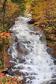 Vibrant waterfall in New England with fall foliage