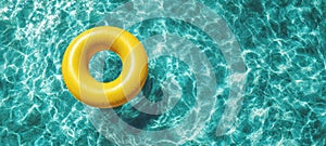 The vibrant yellow inflatable ring floating on crystal-clear pool water. AI generated image